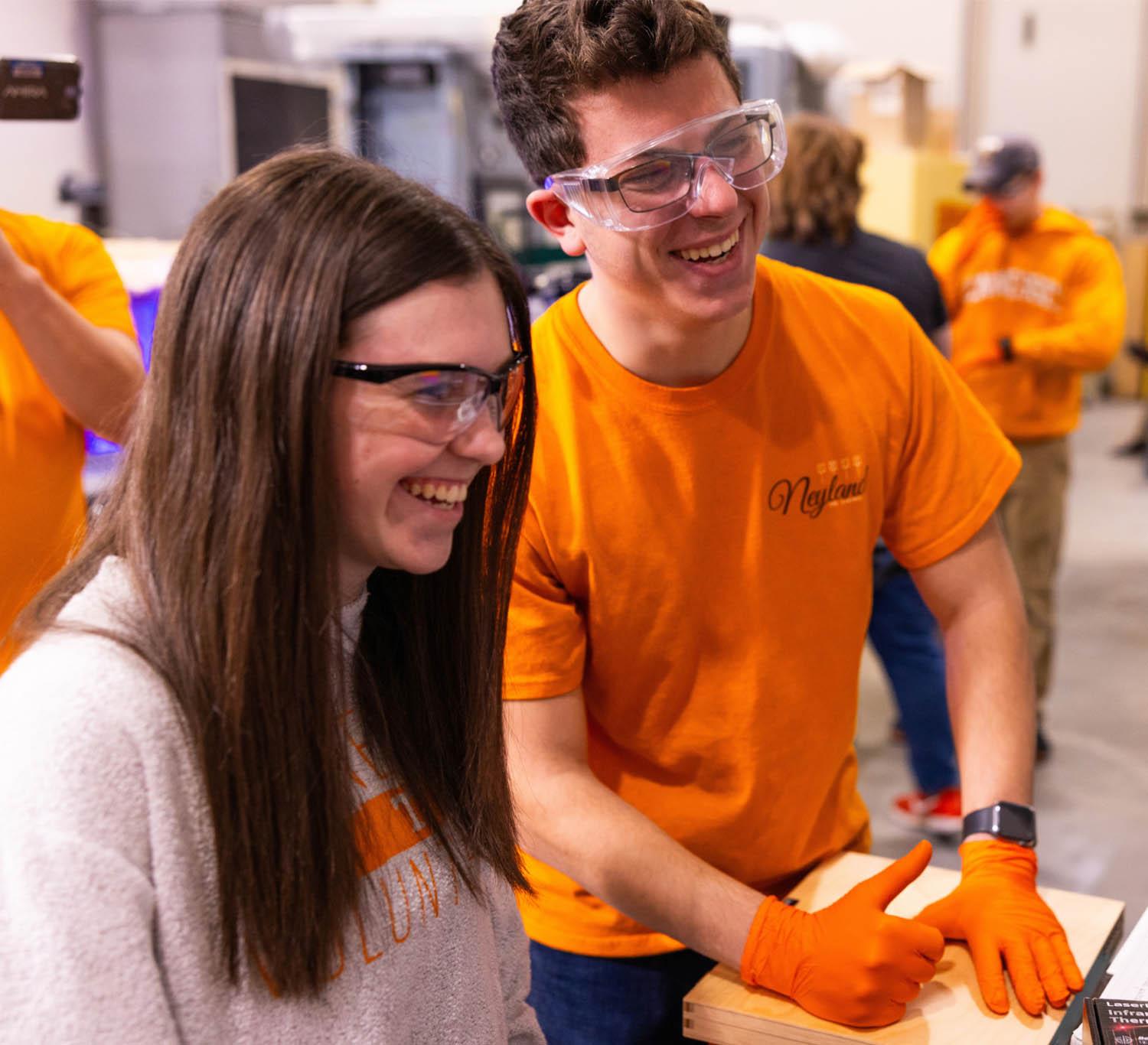 A professor works with students on the MELD Machine inside the Machine Tool Research Center in the Dougherty Engineering Building.